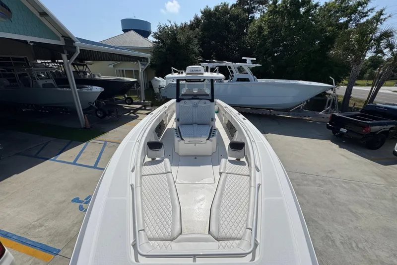 Slide: The Image of 2023 Fountain Bluewater 38 CC boat docked at a marina, showcasing sleek design. - 18