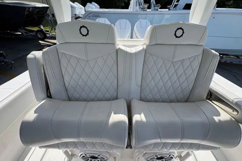 Slide: The Image of Luxury seating on 2023 Fountain Bluewater 38 CC boat, featuring diamond-stitched upholstery. - 24
