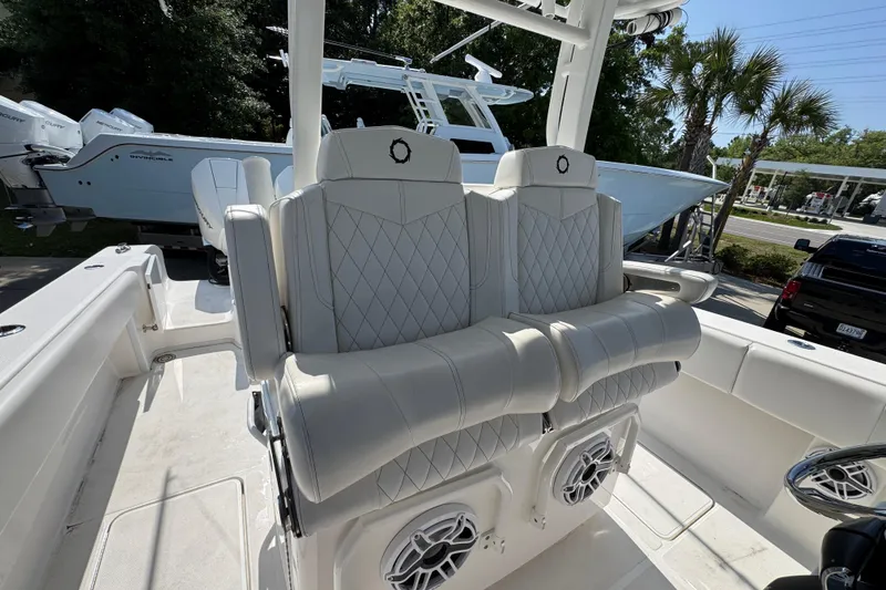 Slide: The Image of 2023 Fountain Bluewater 38 CC boat interior with luxurious seating and speakers. - 26