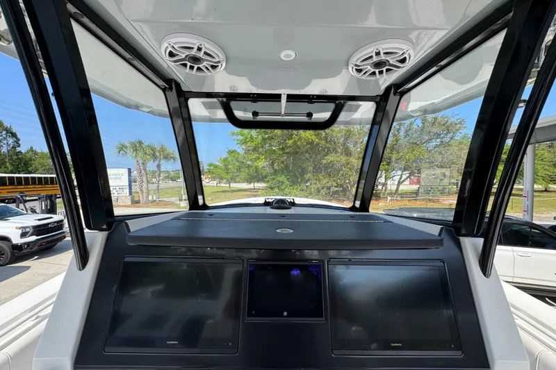 Slide: The Image of 2023 Fountain Bluewater 38 CC dashboard with dual screens and overhead speakers. - 29