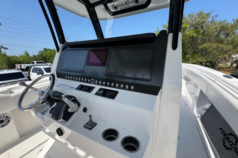 Slide: The Image of 2023 Fountain Bluewater 38 CC boat dashboard with steering wheel and digital displays. - 30