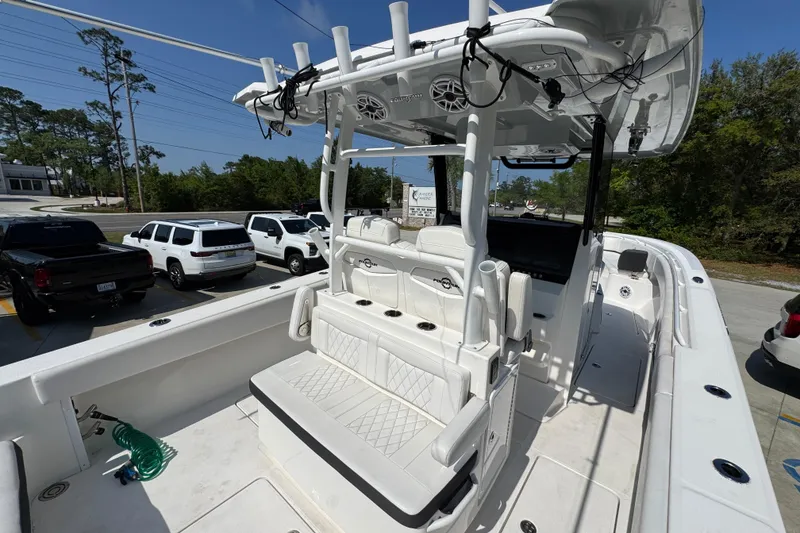 Slide: The Image of 2023 Fountain Bluewater 38 CC boat with white seating and fishing rod holders. - 33