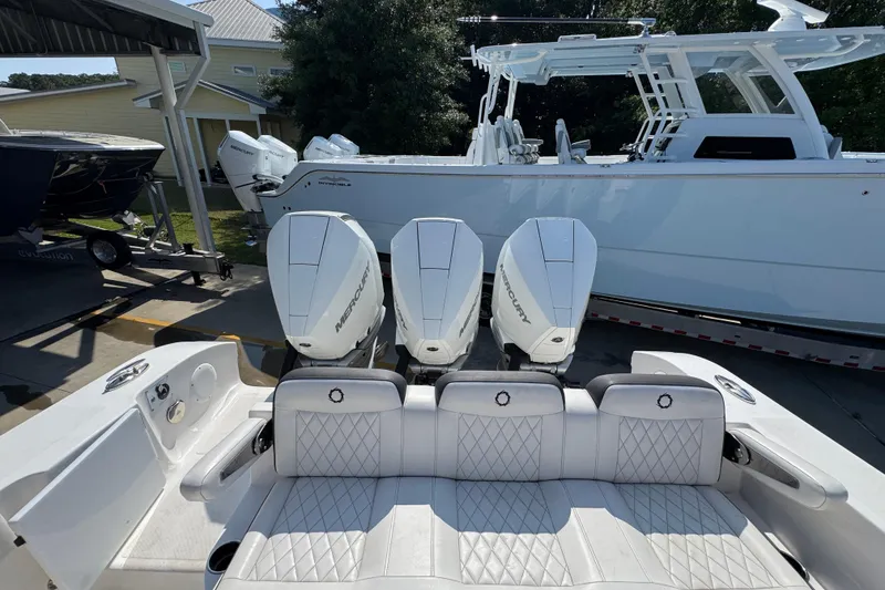 Slide: The Image of 2023 Fountain Bluewater 38 CC boat with triple Mercury engines, docked outdoors. - 35