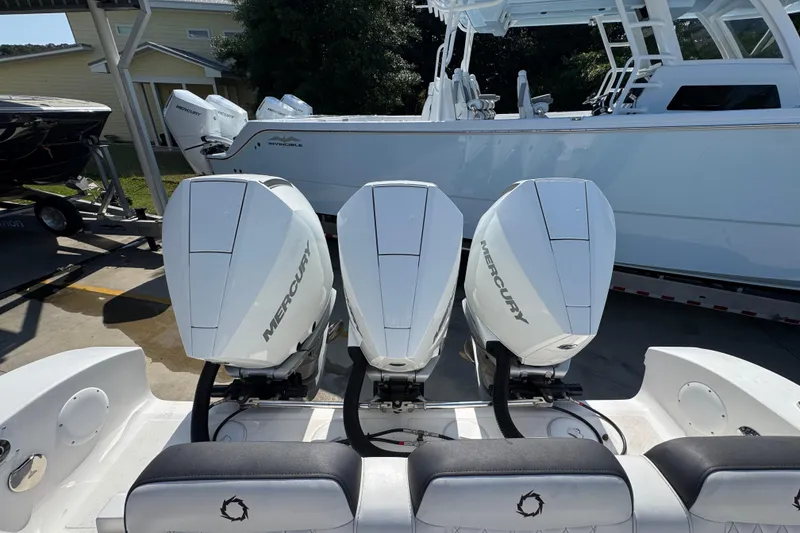 Slide: The Image of 2023 Fountain Bluewater 38 CC with triple Mercury outboard engines, docked in a marina. - 36