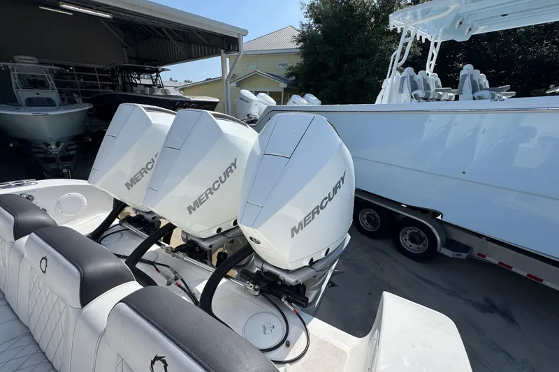 Slide: The Image of 2023 Fountain Bluewater 38 CC with triple Mercury outboard engines in a boatyard. - 37