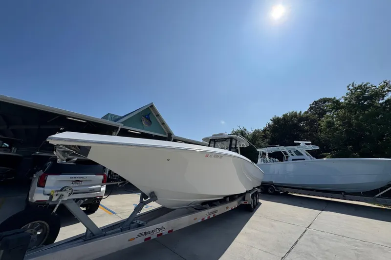 Slide: The Image of 2023 Fountain Bluewater 38 CC boat on trailer under clear blue sky. - 4