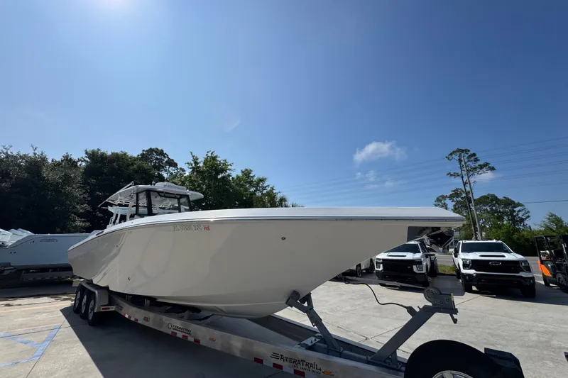 Slide: The Image of 2023 Fountain Bluewater 38 CC boat on trailer under clear blue sky. - 6