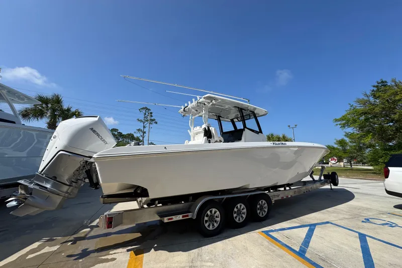 Slide: The Image of 2023 Fountain Bluewater 38 CC boat on trailer under clear blue sky. - 8
