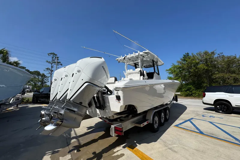 Slide: The Image of 2023 Fountain Bluewater 38 CC boat on trailer with triple outboard engines. - 9