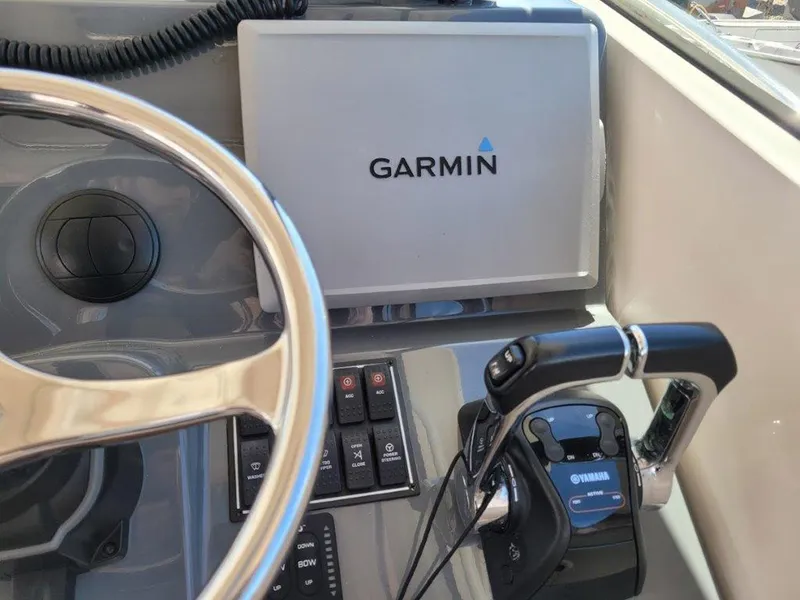 Slide: The Image of Steering wheel and Garmin navigation system on 2013 Pursuit 345 OS Offshore boat. - 17