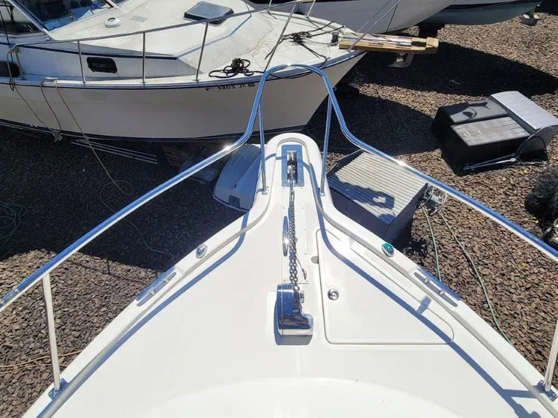 Slide: The Image of Bow view of 2013 Pursuit 345 OS Offshore boat, showcasing anchor and deck details. - 6