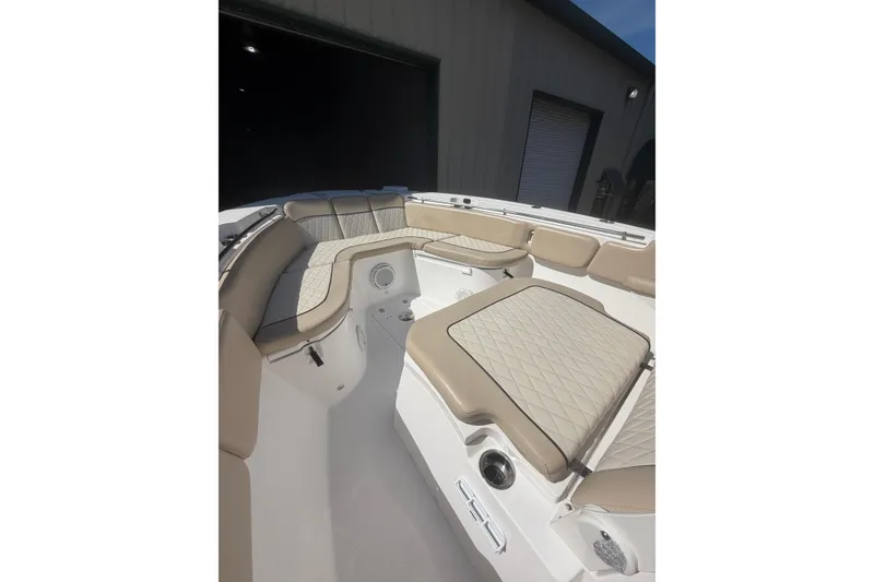Slide: The Image of 2018 Seafox 288 Commander boat interior with beige cushioned seating and diamond stitching. - 10