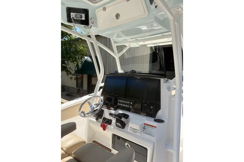 Slide: The Image of 2018 Seafox 288 Commander boat helm with modern navigation equipment and steering wheel. - 13