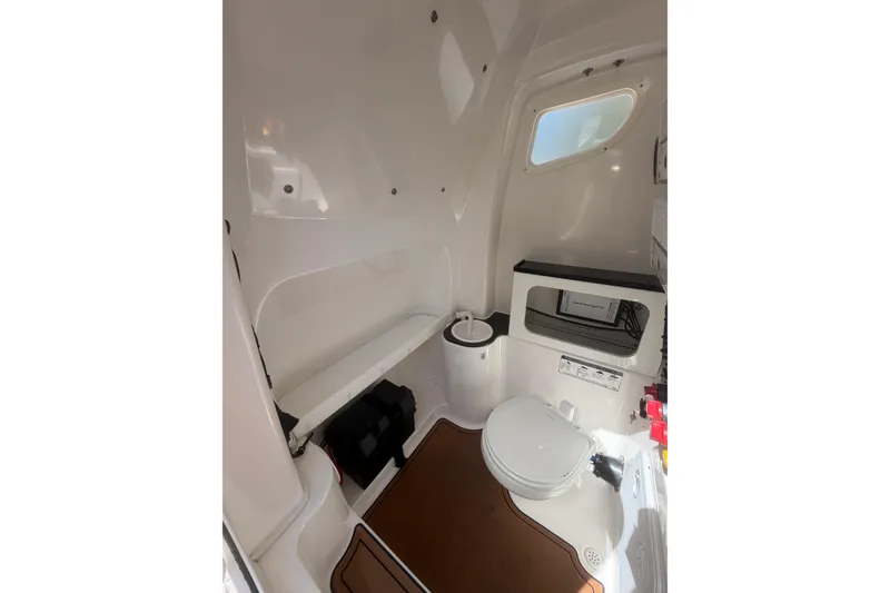 Slide: The Image of Interior of 2018 Seafox 288 Commander boat, featuring a compact marine toilet. - 15