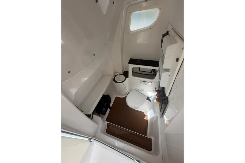 Slide: The Image of Interior of 2018 Seafox 288 Commander boat, featuring a compact, well-equipped bathroom. - 16