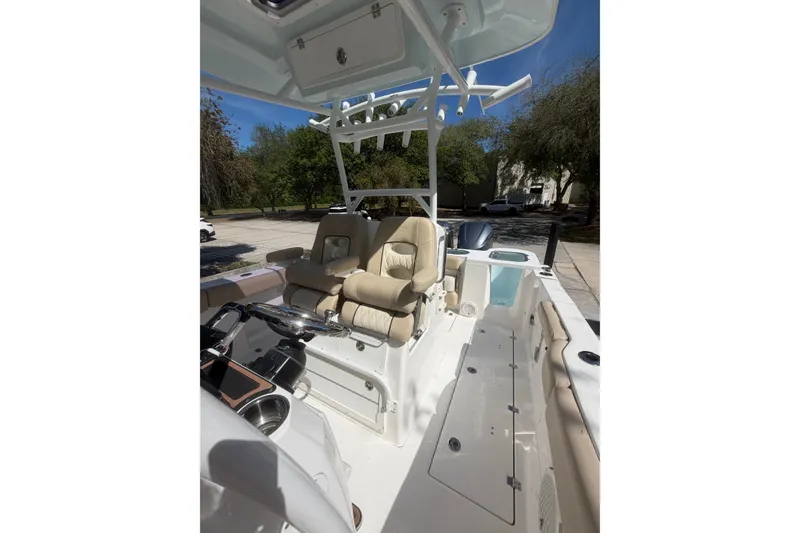 Slide: The Image of 2018 Seafox 288 Commander boat interior with beige seating and steering console. - 17