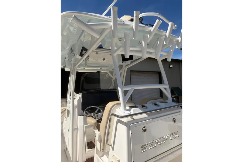 Slide: The Image of 2018 Seafox 288 Commander boat with helm and rod holders, docked outdoors. - 19