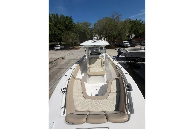 Slide: The Image of 2018 Seafox 288 Commander boat with beige seating, docked outdoors. - 23