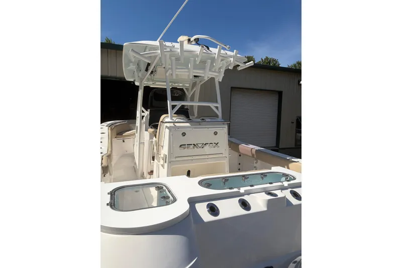 Slide: The Image of 2018 Seafox 288 Commander boat with fishing rod holders and livewell, docked outdoors. - 6
