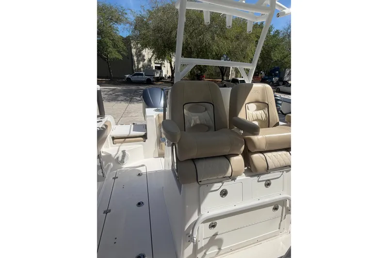 Slide: The Image of 2018 Seafox 288 Commander boat interior with beige seating and storage compartments. - 9