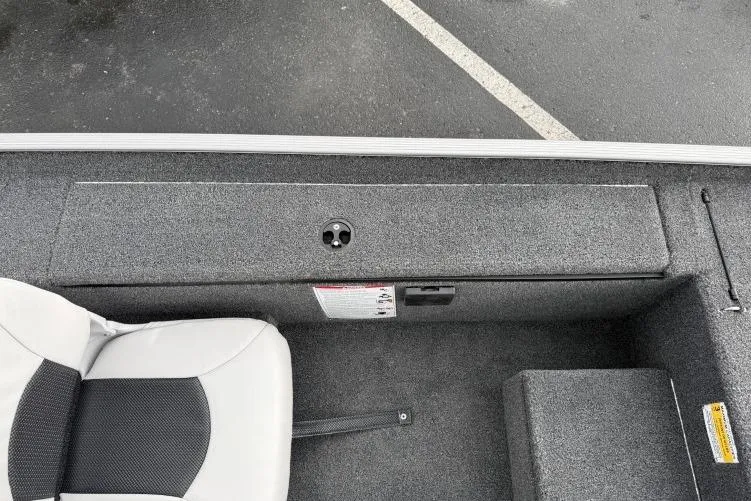 Slide: The Image of 2026 Crestliner 1600 Storm boat interior with gray seating and storage compartment. - 10