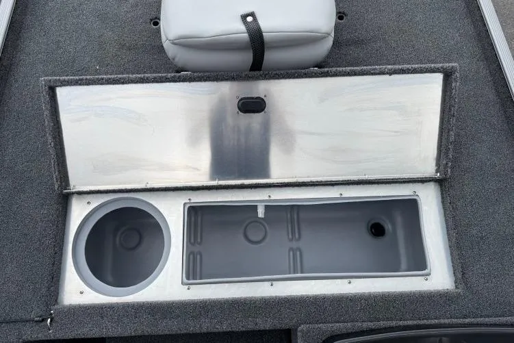 Slide: The Image of 2026 Crestliner 1600 Storm boat storage compartments with open lid, showcasing interior design. - 4