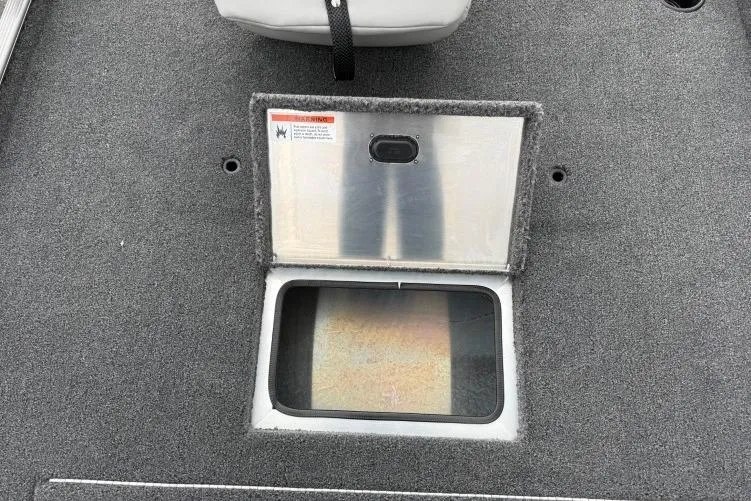 Slide: The Image of Open storage compartment on 2026 Crestliner 1600 Storm boat deck. - 5