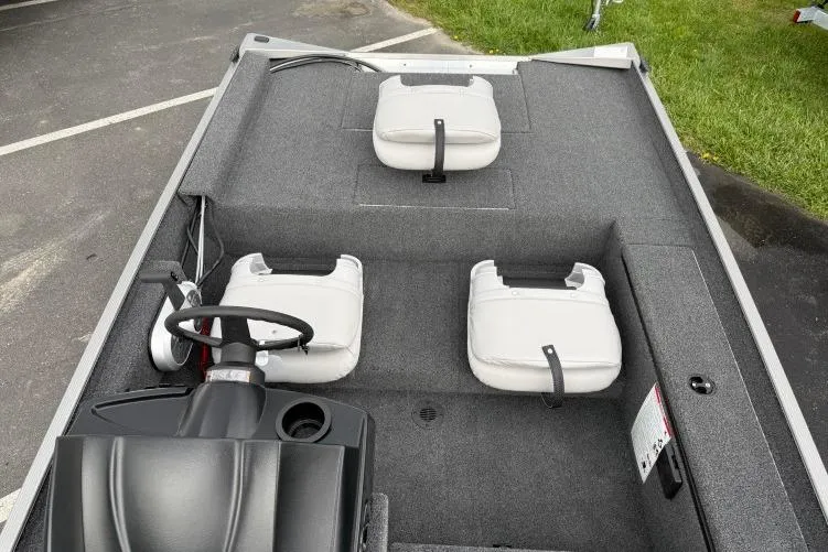 Slide: The Image of 2026 Crestliner 1600 Storm boat interior with gray carpet and white seats. - 6