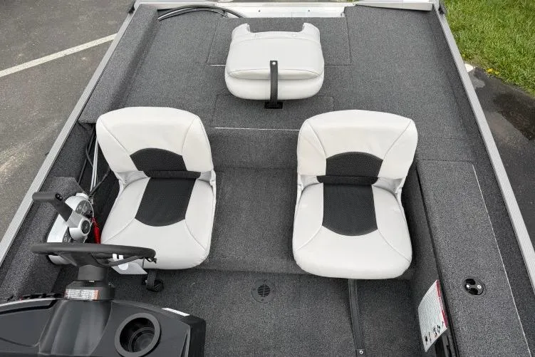 Slide: The Image of 2026 Crestliner 1600 Storm boat interior with two gray seats and steering console. - 7