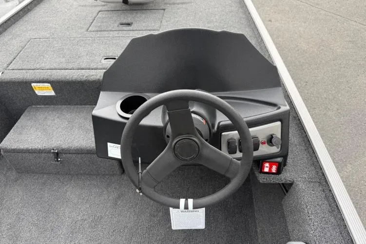 Slide: The Image of Steering console of 2026 Crestliner 1600 Storm boat with cup holder and controls. - 8