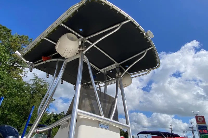 Slide: The Image of 1999 Pathfinder 2200 Tournament Edition boat with T-top under a clear blue sky. - 7