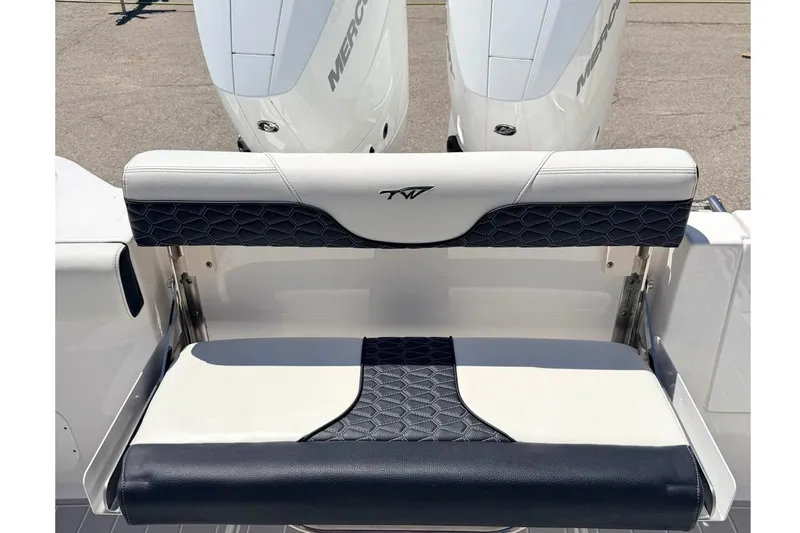 Slide: The Image of 2024 Tidewater 320 CC Adventure boat with dual Mercury engines and cushioned seating. - 10