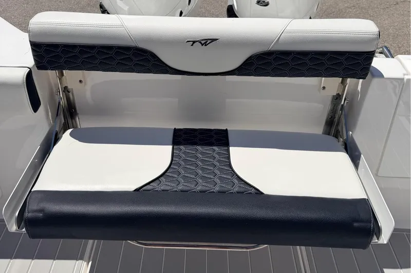 Slide: The Image of 2024 Tidewater 320 CC Adventure boat with dual Mercury engines and stylish seating. - 12