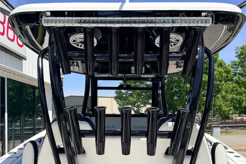 Slide: The Image of 2024 Tidewater 320 CC Adventure boat with sleek black T-top and rod holders. - 13