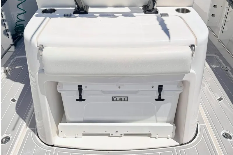 Slide: The Image of 2024 Tidewater 320 CC Adventure boat interior with seating and Yeti cooler. - 14