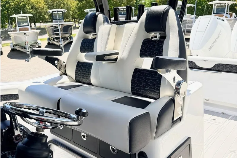 Slide: The Image of 2024 Tidewater 320 CC Adventure boat interior with dual seats and steering wheel. - 17