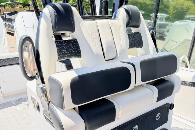 Slide: The Image of 2024 Tidewater 320 CC Adventure boat seating with black and white upholstery. - 18