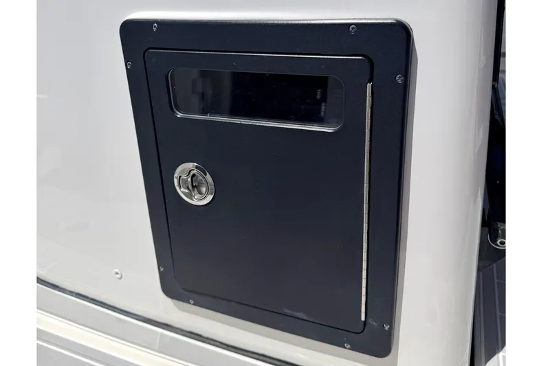 Slide: The Image of 2024 Tidewater 320 CC Adventure boat storage compartment with lockable door. - 20