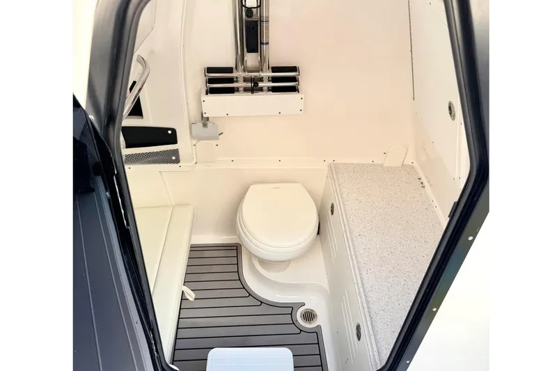Slide: The Image of 2024 Tidewater 320 CC Adventure boat interior with compact bathroom and modern fixtures. - 25