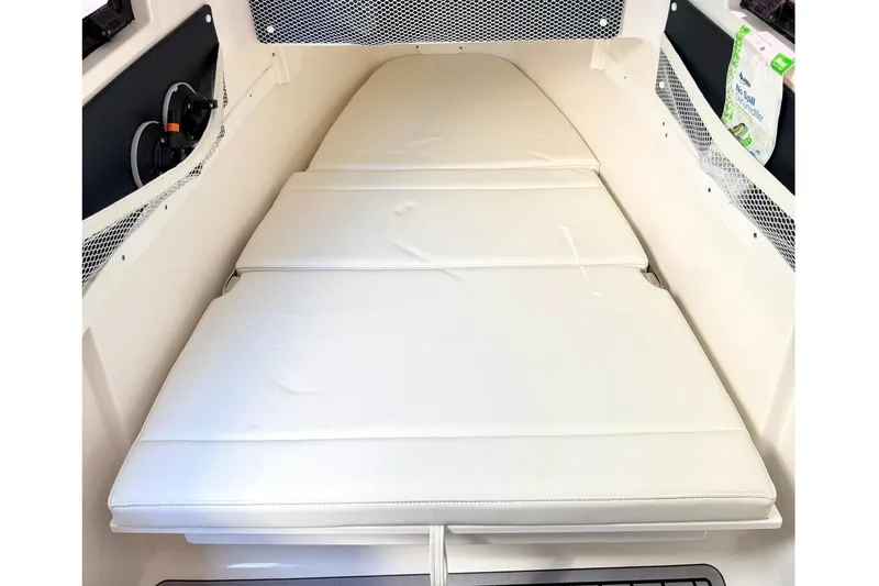 Slide: The Image of 2024 Tidewater 320 CC Adventure cabin interior with cushioned seating and storage. - 27