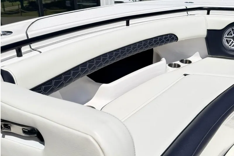 Slide: The Image of 2024 Tidewater 320 CC Adventure boat interior with white seating and cup holders. - 33