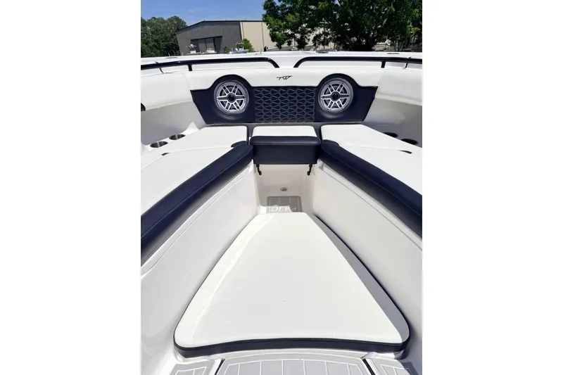 Slide: The Image of 2024 Tidewater 320 CC Adventure boat interior with cushioned seating and speakers. - 37