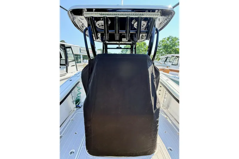 Slide: The Image of 2024 Tidewater 320 CC Adventure boat console with protective cover and T-top. - 38