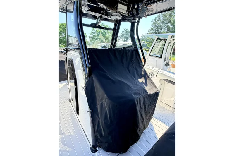 Slide: The Image of 2024 Tidewater 320 CC Adventure boat interior with covered console. - 39