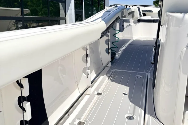 Slide: The Image of 2024 Tidewater 320 CC Adventure boat deck, sleek design, modern features, outdoor showroom. - 6