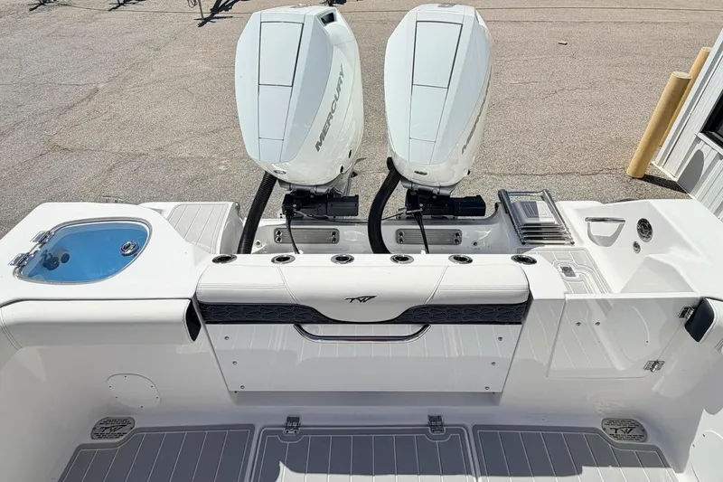 Slide: The Image of 2024 Tidewater 320 CC Adventure boat with dual engines in a marina setting. - 7