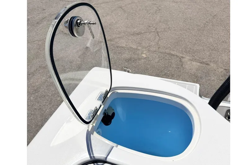 Slide: The Image of Open hatch on 2024 Tidewater 320 CC Adventure boat, revealing blue interior compartment. - 9