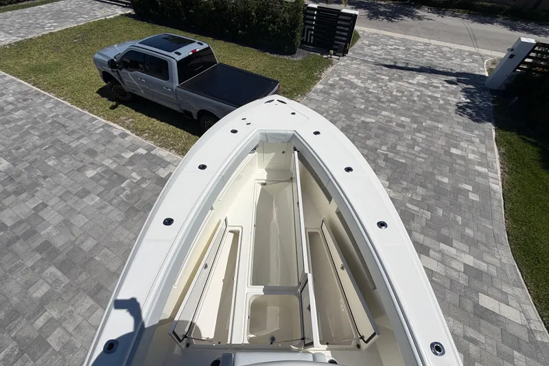 Slide: The Image of Aerial view of 2021 SeaVee 322Z boat on driveway beside a parked truck. - 13