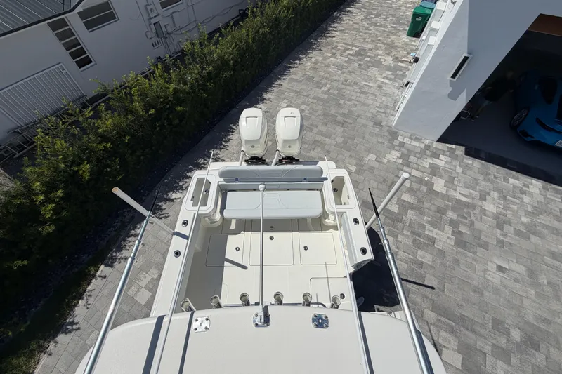 Slide: The Image of 2021 SeaVee 322Z boat with dual engines, parked on a paved driveway. - 14
