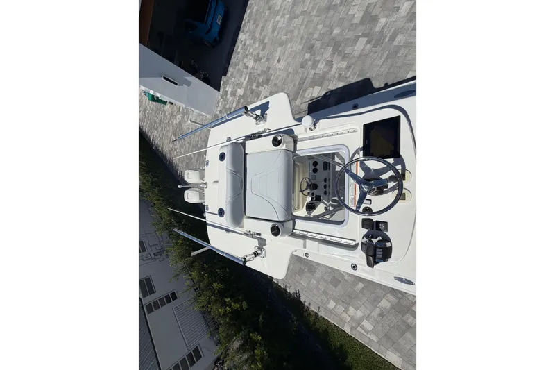 Slide: The Image of 2021 SeaVee 322Z boat, aerial view of helm and deck on paved surface. - 15